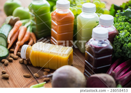 bottles with different fruit or vegetable juices 28058453