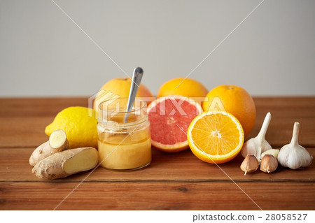 honey, citrus fruits, ginger and garlic on wood honey, citrus fruits, ginger and garlic on wood 28058527