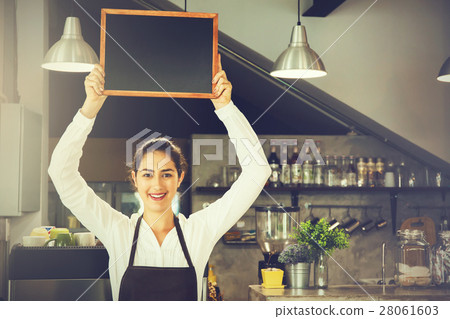 Beautiful Caucasian woman holding empty blackboard 28061603