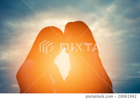 Silhouette woman lover friend at sunset Silhouette woman lover friend at sunset 28061992