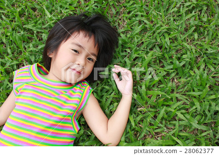 Young little girl relaxing in the park Young little girl relaxing in the park 28062377