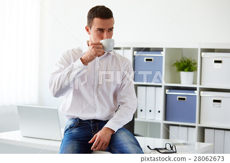 Man in a polo shirt stands leaning on railing Man in a polo shirt stands leaning on railing 28062673