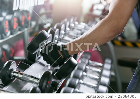 Asian sport man doing one-arm dumbbell rows. 28064303