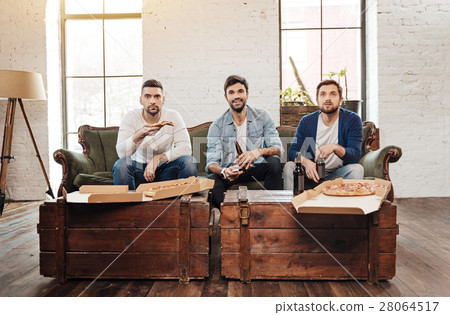 Good looking young men watching TV Good looking young men watching TV 28064517