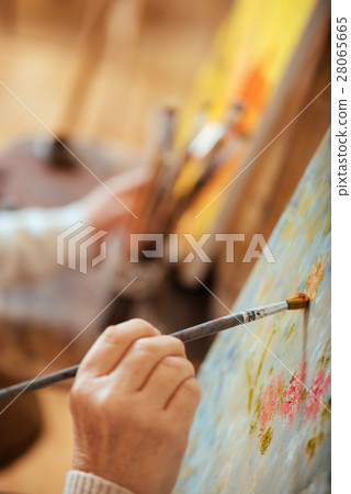 Close up of artists hand painting with brush Close up of artists hand painting with brush 28065665