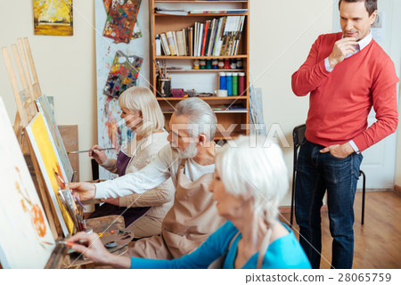 Concentrated artist controlling his colleagues in Concentrated artist controlling his colleagues in 28065759