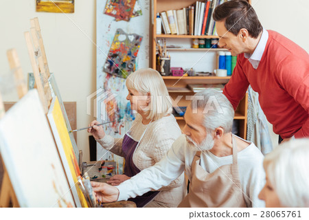 Handsome artist controlling his colleagues in Handsome artist controlling his colleagues in 28065761