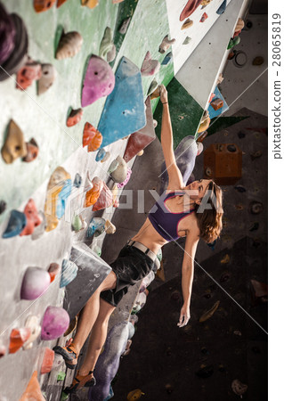 woman bouldering in climbing gym 28065819