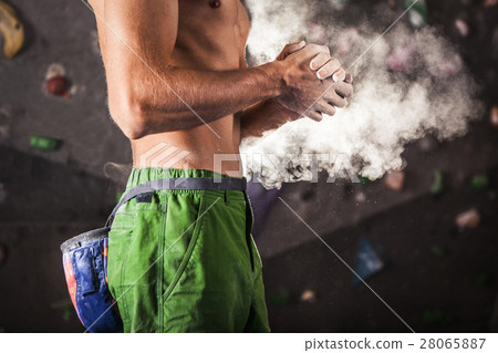 Climber man coating his hands in powder chalk magnesium Climber man coating his hands in powder chalk magnesium 28065887