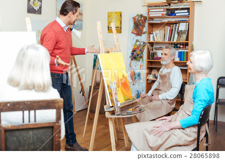 Handsome artist lecturing in painting school Handsome artist lecturing in painting school 28065898