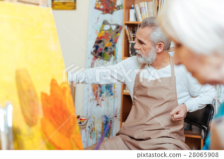 Serious artist working in painting studio. 28065908