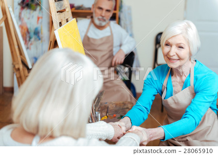 Female artists talking in painting class. Female artists talking in painting class. 28065910