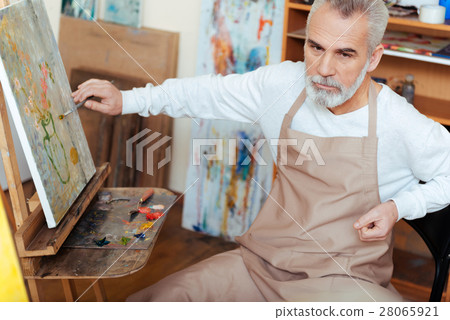 Concentrated artist painting a picture 28065921
