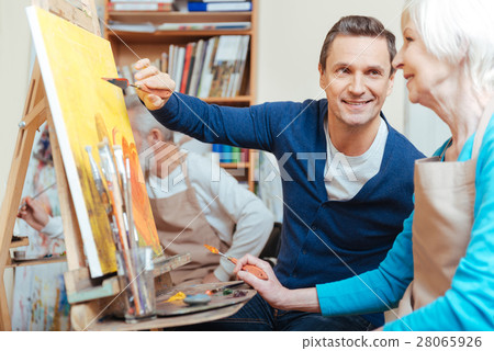 Overjoyed artist helping elderly woman in painting Overjoyed artist helping elderly woman in painting 28065926