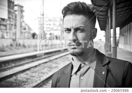 balck and white portrait of young man waiting at the train stat balck and white portrait of young man waiting at the train stat 28065986