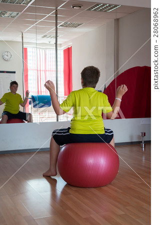 Boy does exercise with the ball Boy does exercise with the ball 28068962