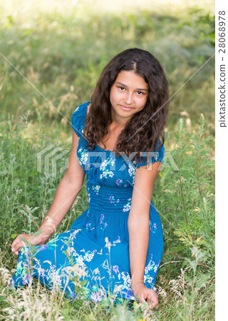 young pretty girl with  curly hair outdoors 28068978
