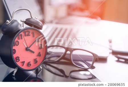 Office work desk with clock showing 4pm to finish Office work desk with clock showing 4pm to finish 28069635