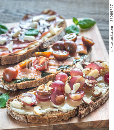 Bruschetta with different toppings Bruschetta with different toppings 28069767