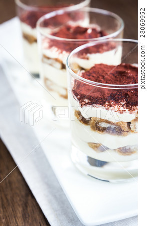 Tiramisu in the glasses on the wooden background Tiramisu in the glasses on the wooden background 28069952