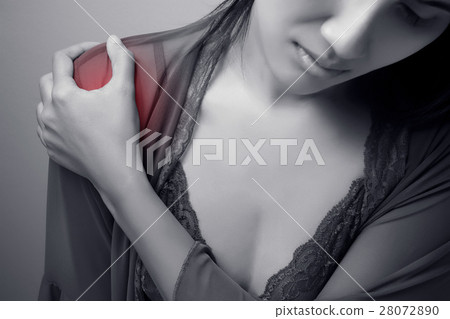 Woman pressing her hand against a painful shoulder Woman pressing her hand against a painful shoulder 28072890
