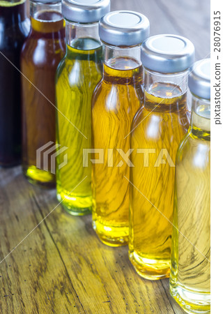 Bottles with different kinds of vegetable oil Bottles with different kinds of vegetable oil 28076915