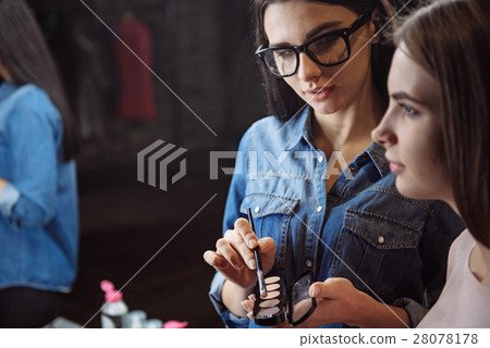 Cute attractive makeup artist applying eyeshadow Cute attractive makeup artist applying eyeshadow 28078178