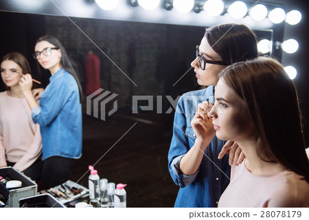 Pleasant professional visagiste looking into the Pleasant professional visagiste looking into the 28078179