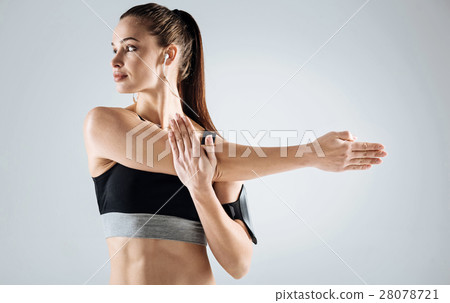 Young girl doing stretching on a grey background Young girl doing stretching on a grey background 28078721