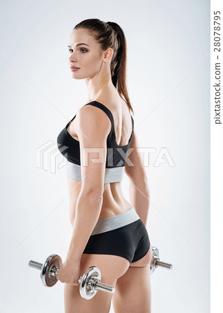Inspired girl posing with dumbbells Inspired girl posing with dumbbells 28078795