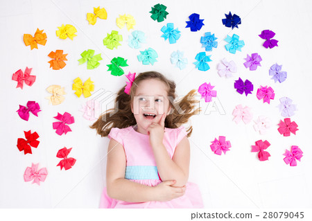 Little girl with colorful bow. Hair accessory 28079045