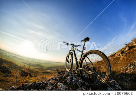 Bicycle silhouettes with blue sky on the mound 28079668