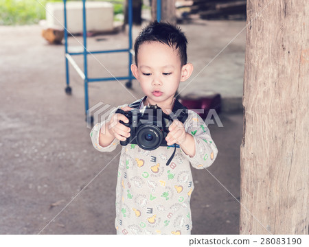 Asian kid take a photo by DSLR camera 28083190