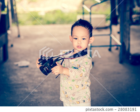 Asian kid take a photo by DSLR camera 28083191