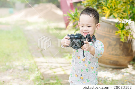 Asian kid take a photo by DSLR camera 28083192