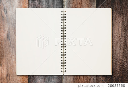 Opened blank binder notebook, with paper on wood  28083368