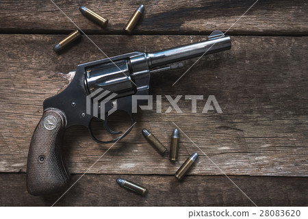 Gun and ammunition on wooden table. top view Gun and ammunition on wooden table. top view 28083620