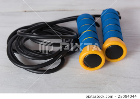 Blue and yellow skipping rope on white wooden  28084044