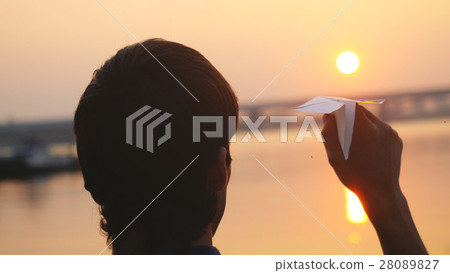 Silhouette of guy launch paper plane against the 28089827