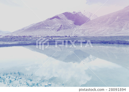 Retro snow pean and green valley landscape Retro snow pean and green valley landscape 28091894