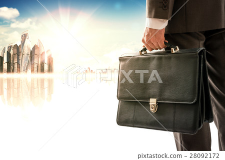 Businessman standing with back against city 28092172