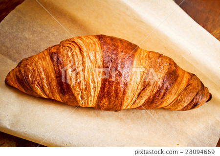 Fresh croissant on brown paper 28094669