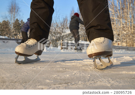 KId skating on ice rink in very cold weather KId skating on ice rink in very cold weather 28095726
