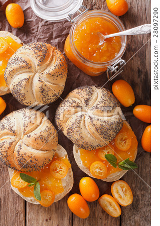 Kumquat jam in a glass jar and sweet sandwiches 28097290