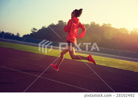 young fitness woman runner running on stadium track 28102492