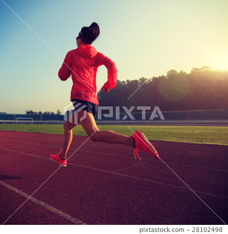 young fitness woman runner running on stadium track 28102498
