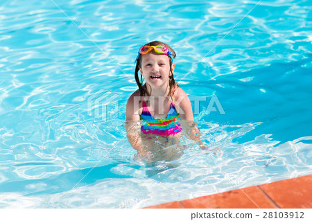 Child learning to swim in pool Child learning to swim in pool 28103912