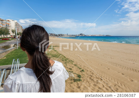 Girl on the empty beach in Spain at autumntime 28106387