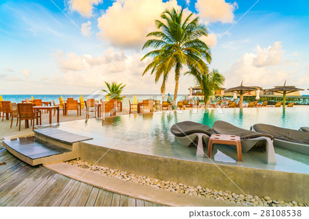 Table and chairs at restaurant in tropical Maldives island . Table and chairs at restaurant in tropical Maldives island . 28108538