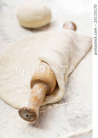 Fresh dough on a board 28110170